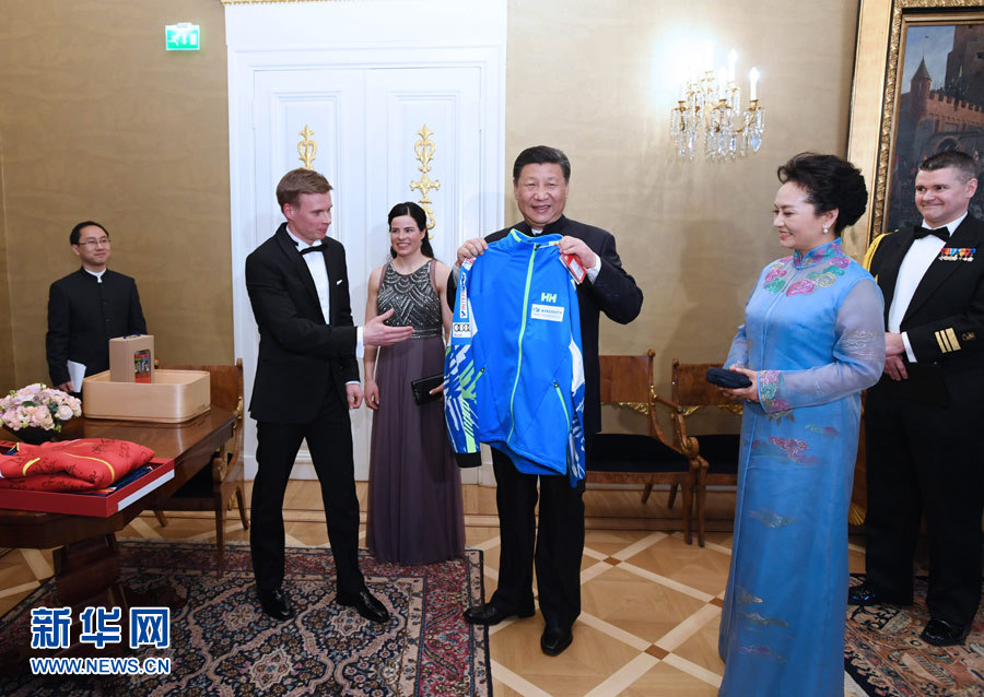 當?shù)貢r間4月5日晚，國家主席習近平和芬蘭總統(tǒng)尼尼斯托在赫爾辛基共同會見剛剛參加完2017年世界花樣滑冰錦標賽的中芬兩國冰雪運動員代表。習近平夫人彭麗媛和尼尼斯托夫人豪吉歐參加會見。這是芬蘭運動員向習近平和夫人彭麗媛贈送運動衣。新華社記者 饒愛民 攝